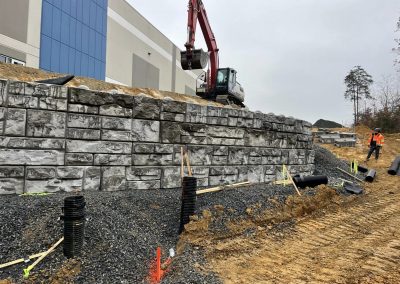 Finishing touches on retaining wall at Kaine